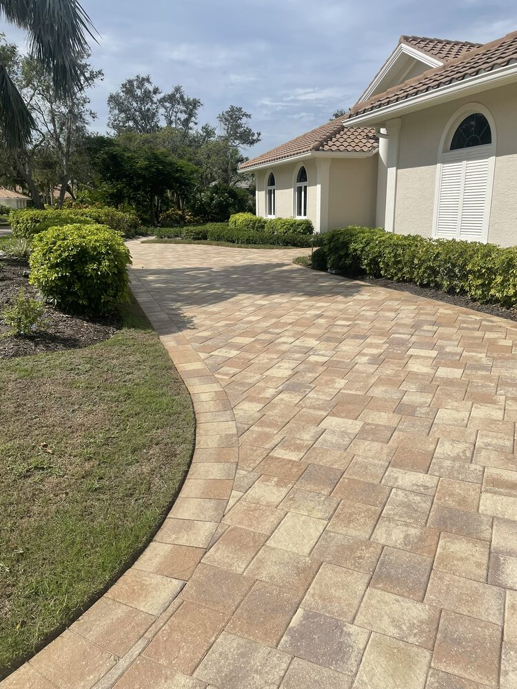 Home with a clean paver driveway