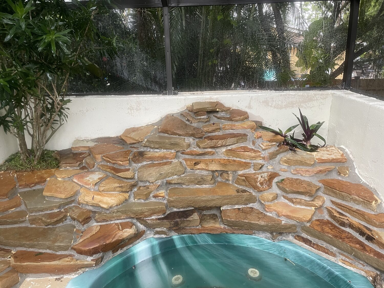 The same stone pool deck after cleaning — bright natural stone